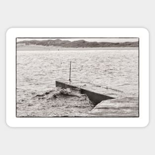 Wave rolling up the harbour wall at Beadnell, Northumberland, UK Sticker